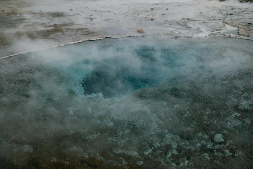 A mesmerizing view of a steaming geyser in Iceland, showcasing nature's geothermal beauty.