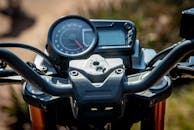 Closed-Up Photo of a Motorcycle Handlebar and Speedometer