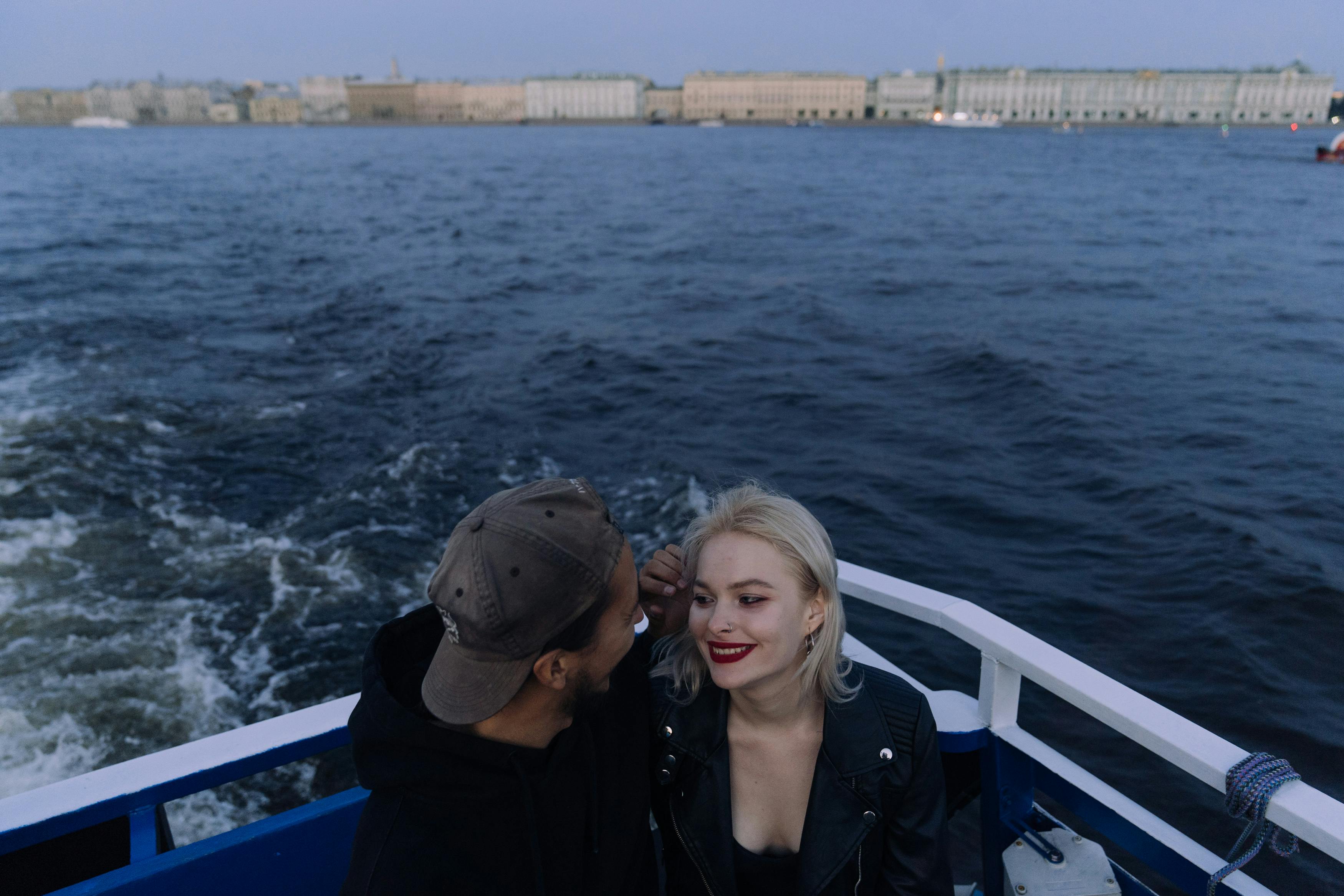 a man and woman looking at each other on the boat