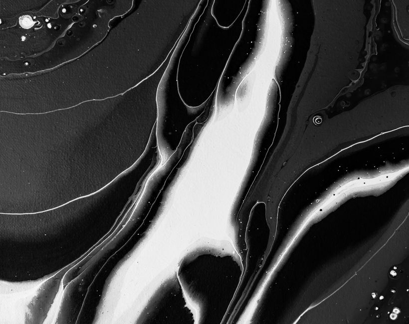 A striking black and white fluid art piece showcasing abstract patterns and textures.