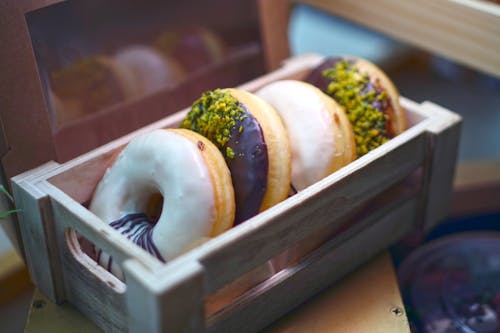 Free Close-Up Shot of Donuts in a Wooden Tray Stock Photo