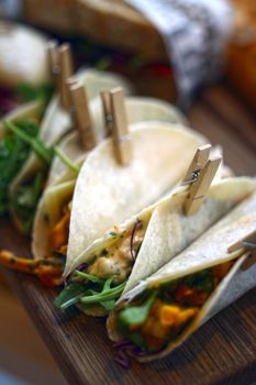 Close-up of mouth-watering vegetarian tacos with fresh vegetables, perfect for food photography.