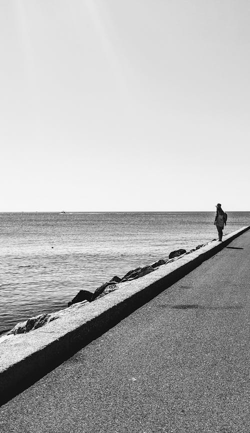Person on Promenade on Sea Shore