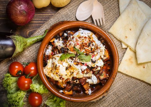 Mouthwatering Middle Eastern meal with fresh tomatoes, eggplant, and herbs.