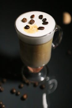 A stylish latte topped with coffee beans, perfect for coffee enthusiasts.