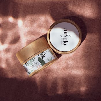 Minimalist eco-friendly cosmetics with natural design on textured background, ideal for skincare enthusiasts.