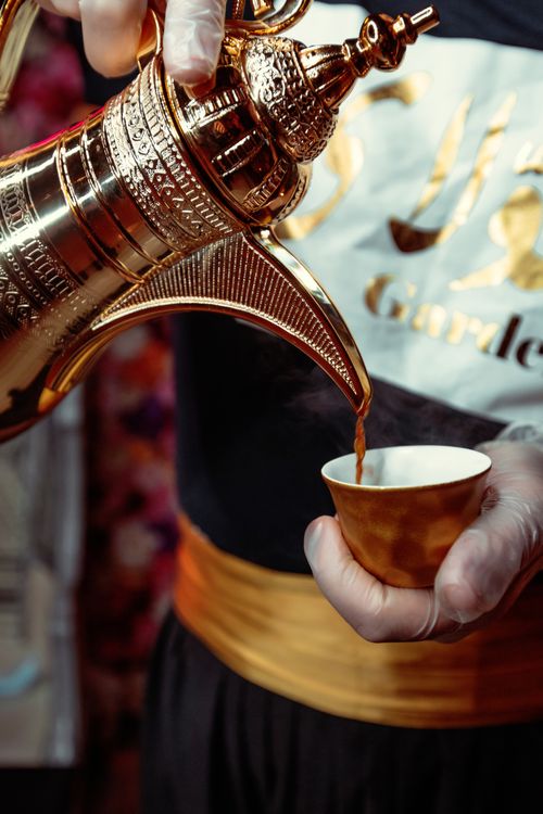 Free Close-up of authentic Arabian coffee being poured from a traditional pot in Dubai, showcasing cultural heritage. Stock Photo