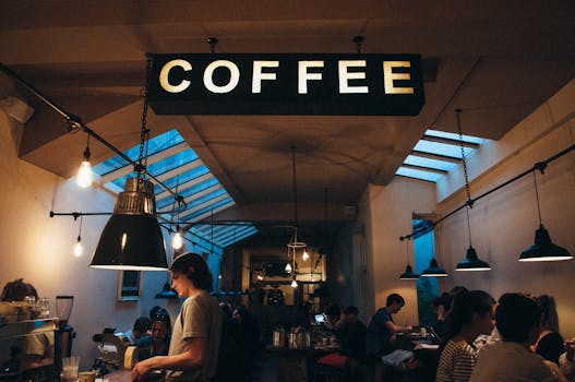 People Sitting at Table Under Coffee Signage