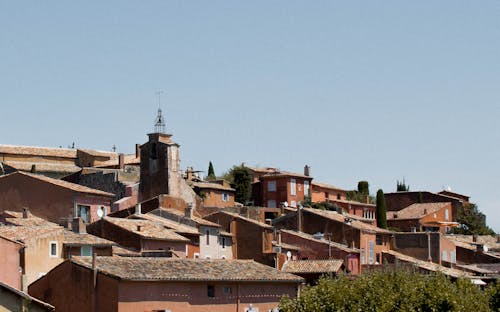 Brown Concrete Houses Under Blue Sky