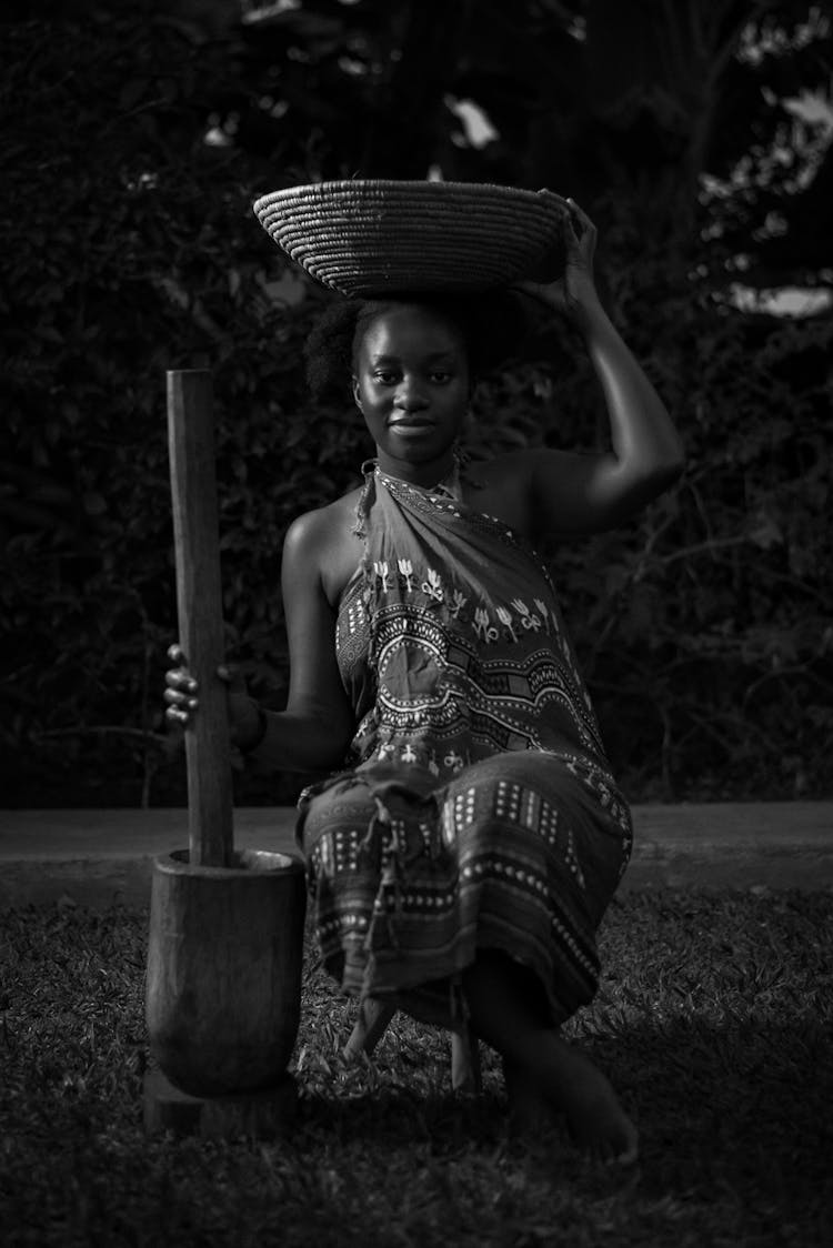 Black Woman In Traditional Clothes With Utensil