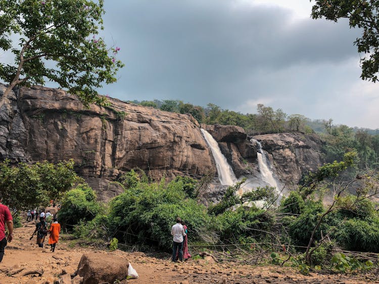 Tourists Looking At The Athirappilly Waterfall 