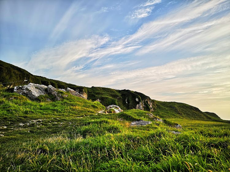 Landscape Of Green Meadows And Cliffs 