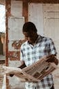 African American man with newspaper in daylight