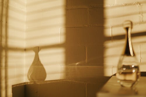 White Window Blinds Near White Ceramic Vase