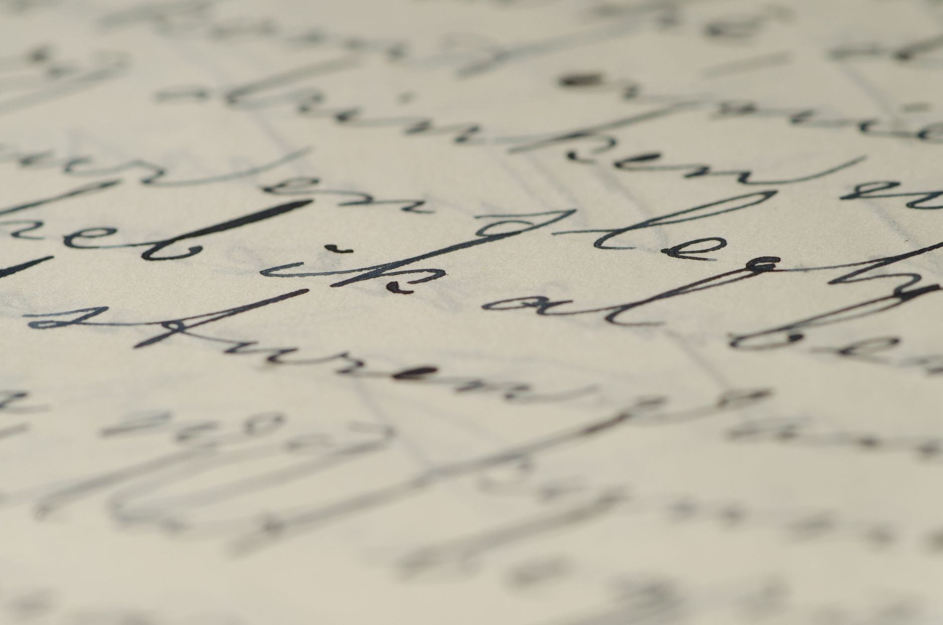 Close-up of elegant handwritten calligraphy on paper showcasing fine ink script. — photo by Pixabay