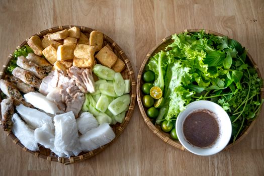 Delicious Vietnamese bun dan mam tom with herbs and fresh vegetables served traditionally.