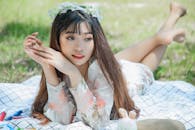 A Woman Lying Down on a Picnic Blanket