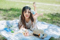 A Woman Lying Down on a Picnic Blanket