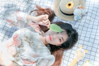 A Woman Lying Down on a Picnic Blanket