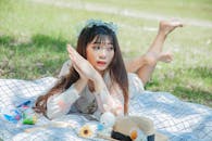 A Woman Lying Down on a Picnic Blanket