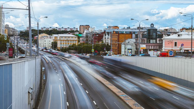 Vibrant Moscow city scene showcasing busy traffic with motion blur under a clear sky.
