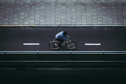 Aerial view of a cyclist riding in a designated bicycle lane on a city road.