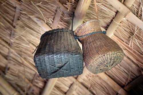 Wicker baskets hanging under thatch roof