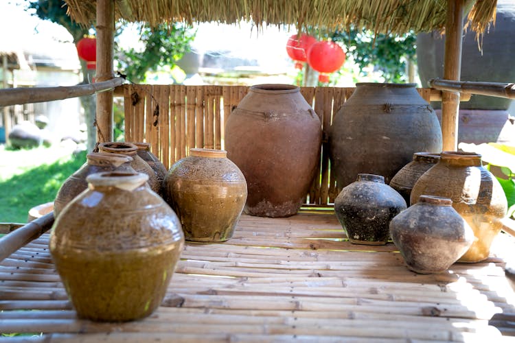 Old Vases On Bamboo Floor In Sunlight