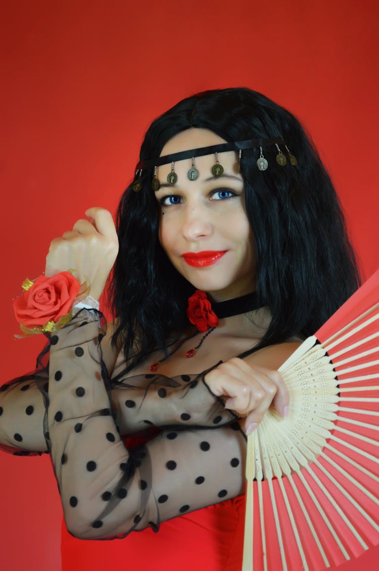 Female Flamenco Dancer With Fan In Studio