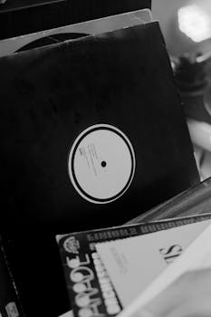 Close-up of vintage vinyl records in black and white, evoking nostalgia.