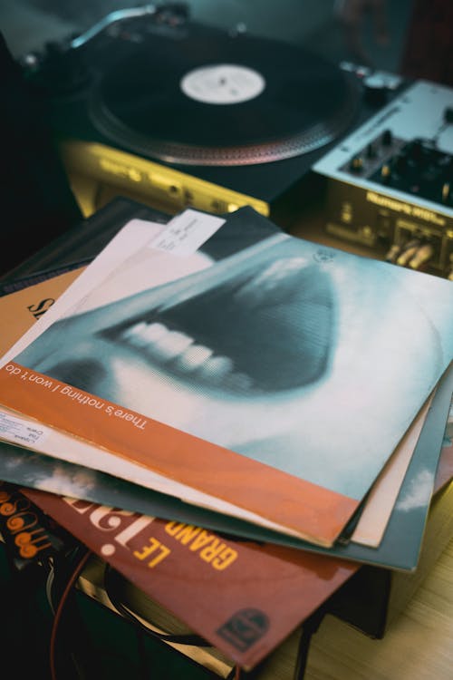 Close-up Photo of Stacked Vinyl Records