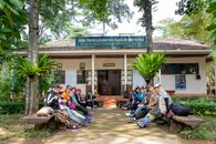 Group of Asian tourists sitting on benches before hiking
