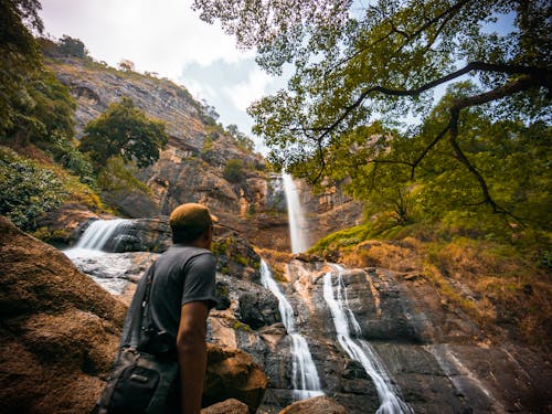 Man Standing near Waterfalls