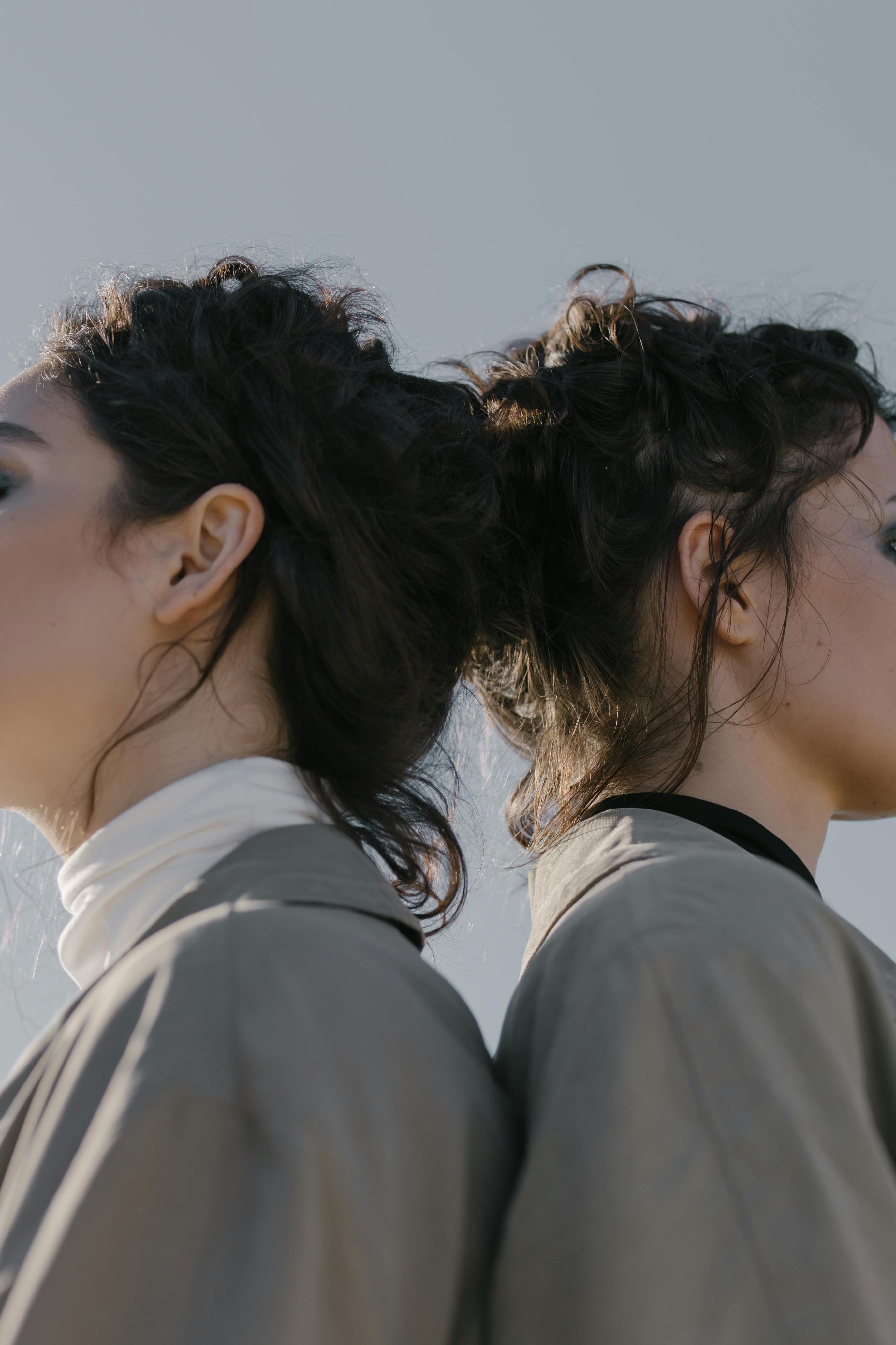 2 women in white shirt kissing each other