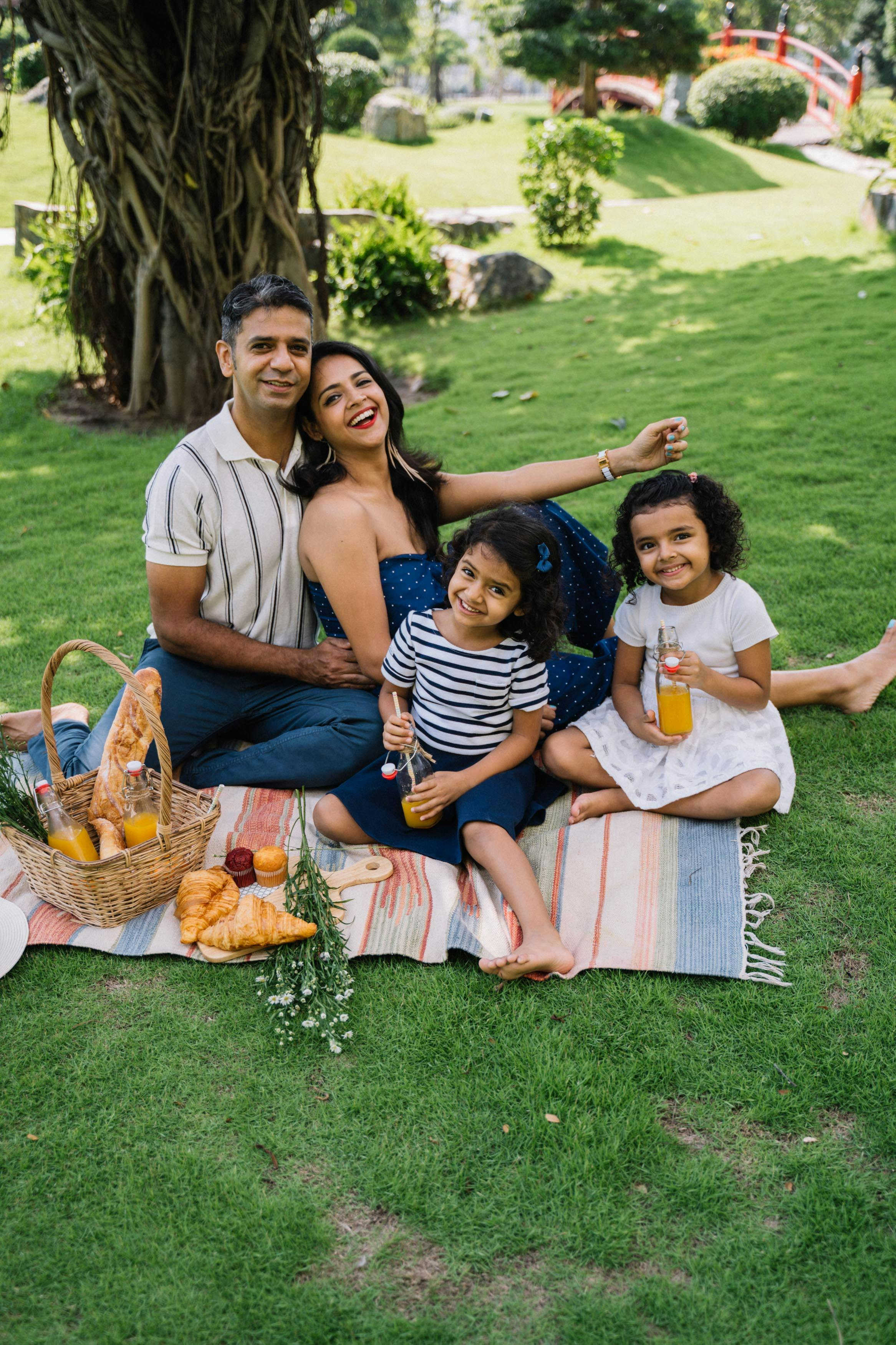 group of people sitting on grass field