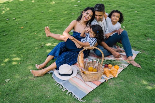 A Family Sitting on a Picnic Blanket
