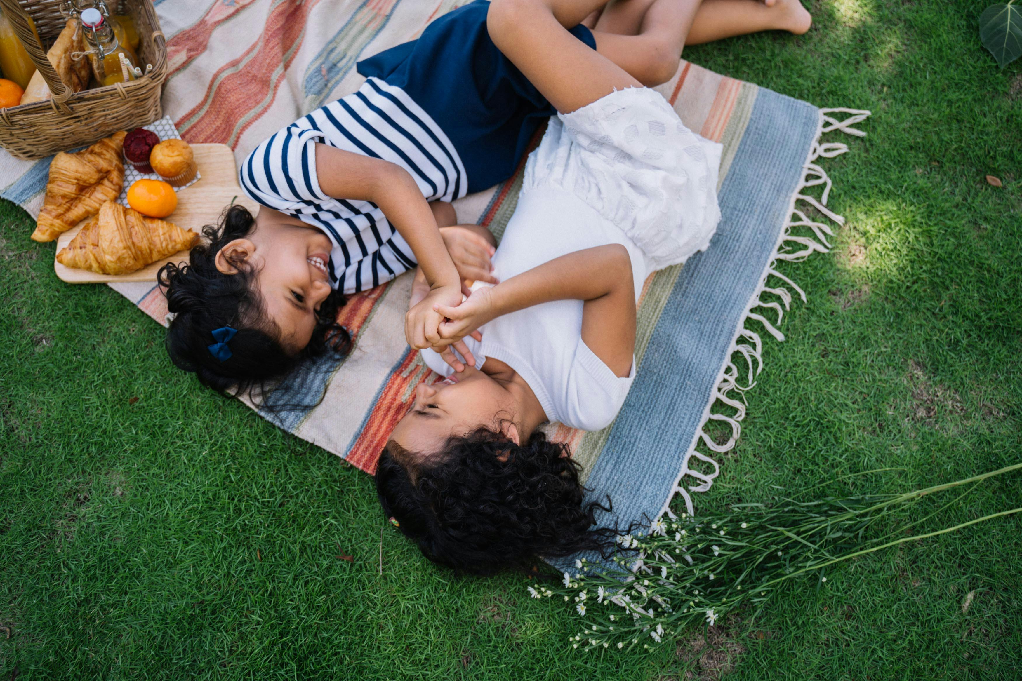 Woman in White Dress Lying on Green Grass