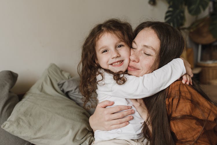 Girl Hugging A Woman