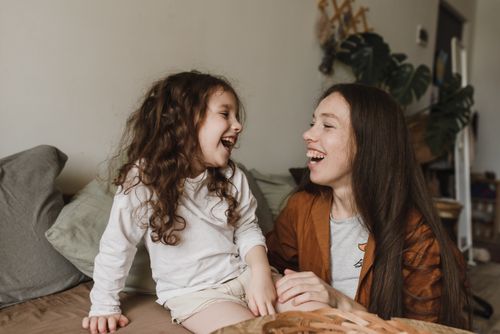 Free Mother and daughter sharing laughter and joy in a cozy indoor setting, highlighting family togetherness. Stock Photo