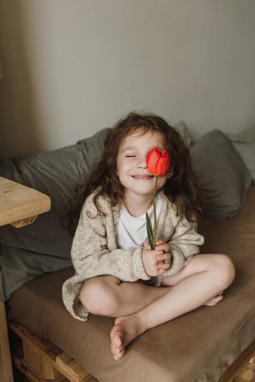 Young Girl holding Red Tulip Flower 