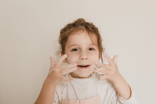 Free Close Up Photo of a Girl Putting Powder on Face Stock Photo