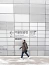 A Man Walking in a City