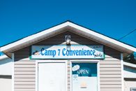 Exterior of contemporary shop with inscription on ribbed wall under bright cloudless sky