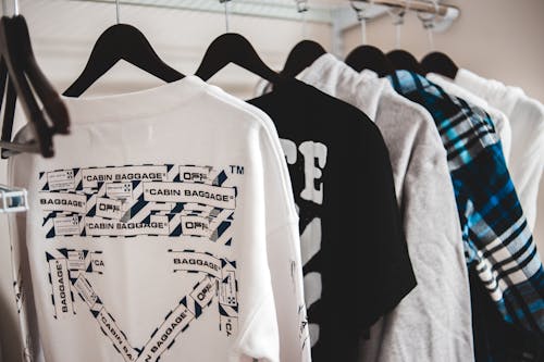 Modern male clothes on hangers in closet