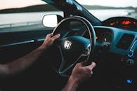 Crop driver driving modern car near river