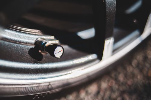 Free Closeup of round chrome disc of contemporary car with metal nipple for checking tire pressure and blowing off and inflating wheel Stock Photo