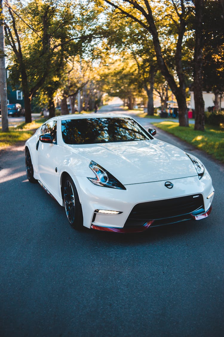 Tuned Sports Car Parked On Road In Park In Summertime