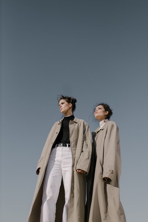 Women Wearing Trench Coats Standing 