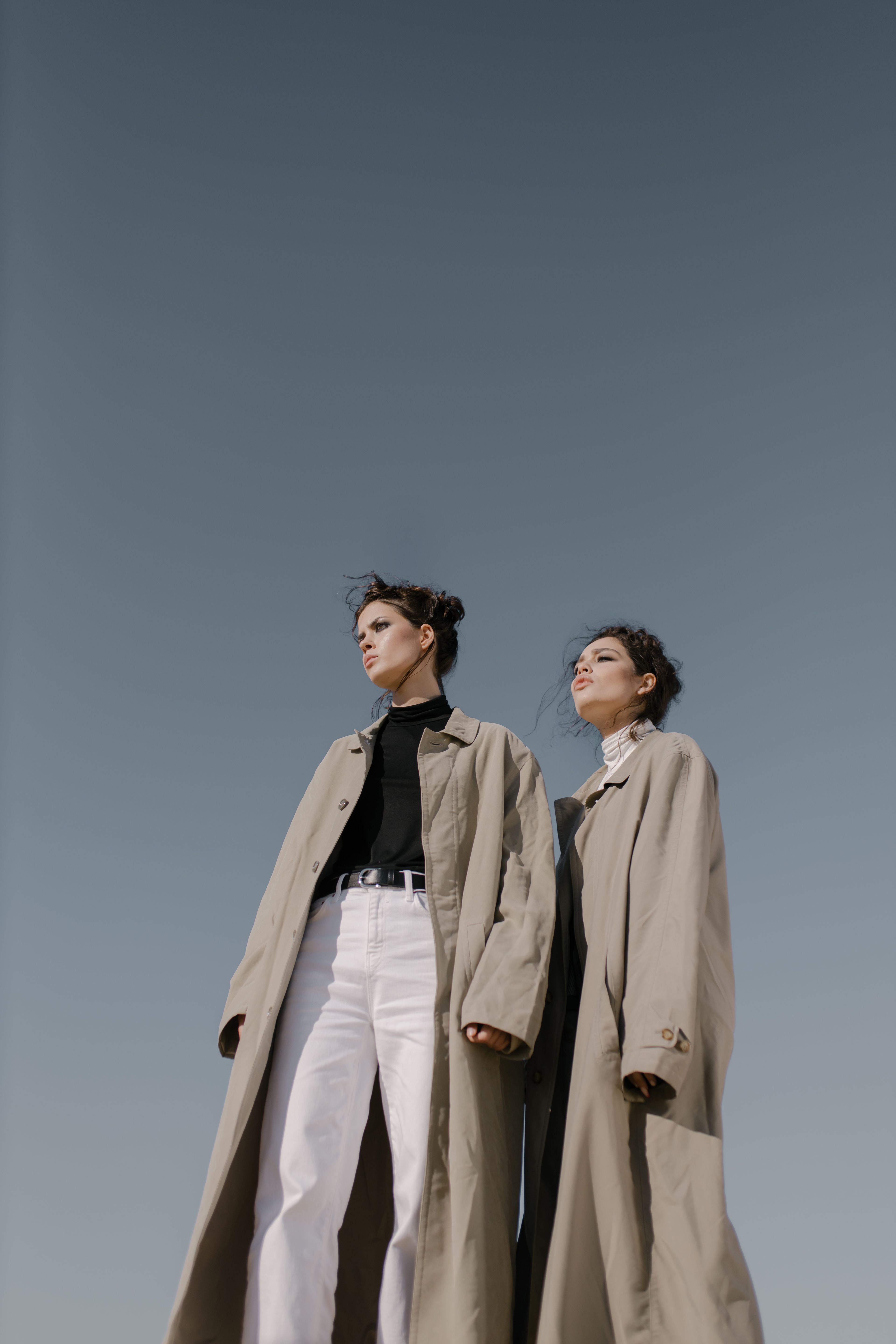 The long coat, worn against a clear sky
