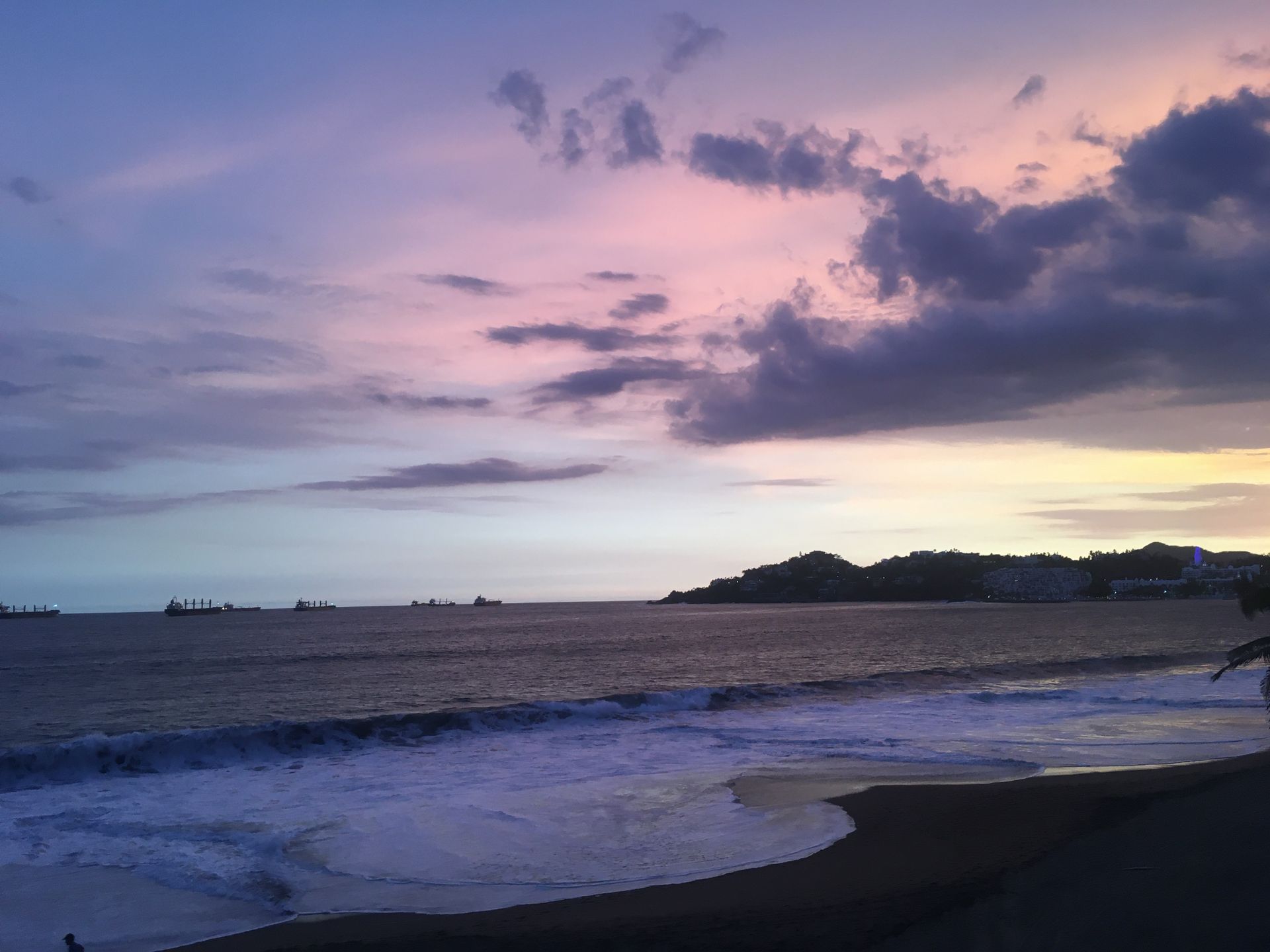 Breathtaking sunset over Manzanillo Beach with vibrant skies and tranquil waters.